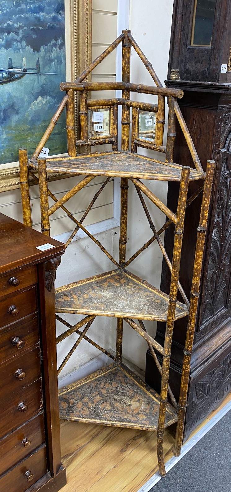 A Victorian bamboo mirrored three tier corner whatnot, width 61cm, depth 34cm, height 160cm